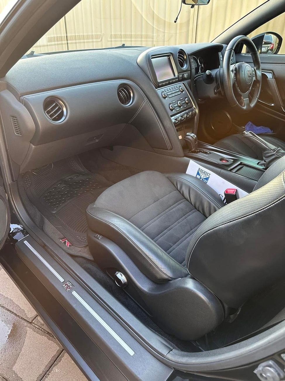 Clean seat, dashboard and floor mat inside a Nissan GT-R