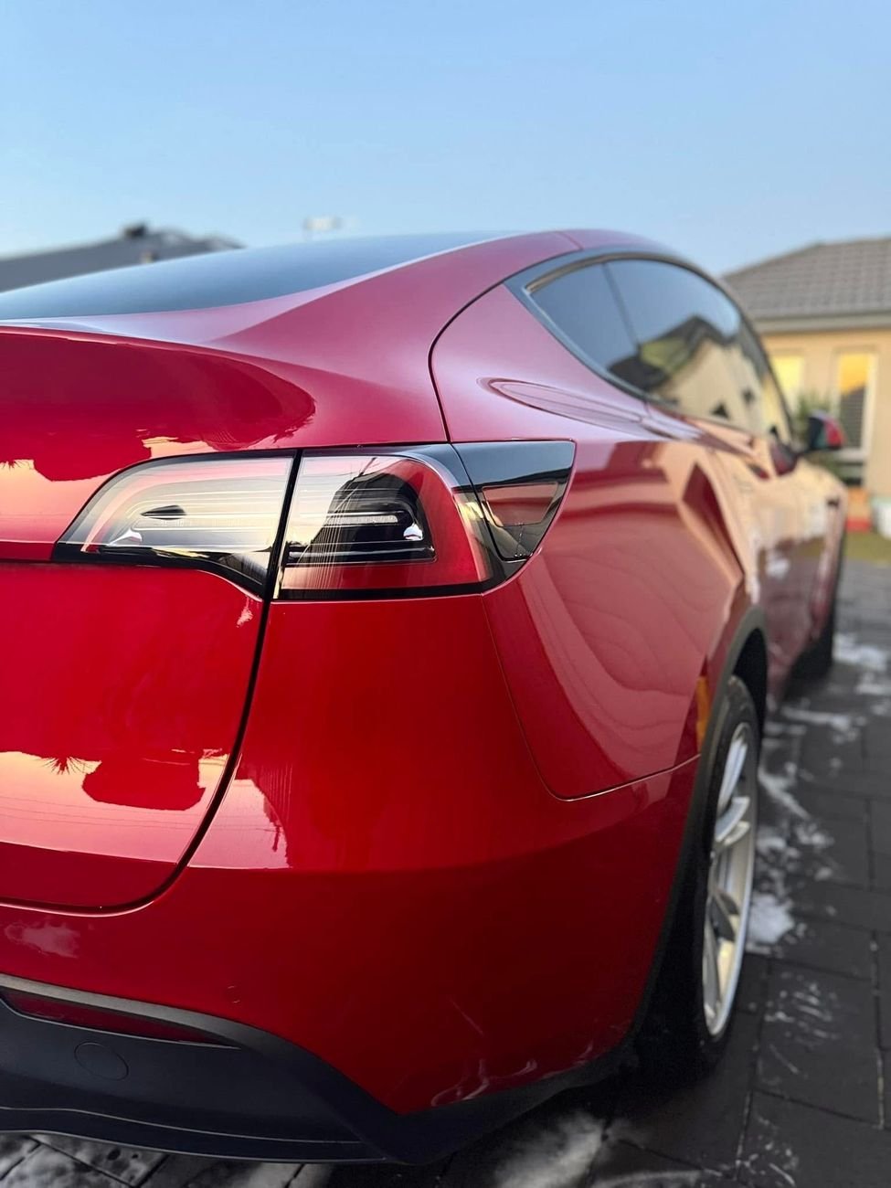 Glossy red paint on a Tesla Model Y after detailing