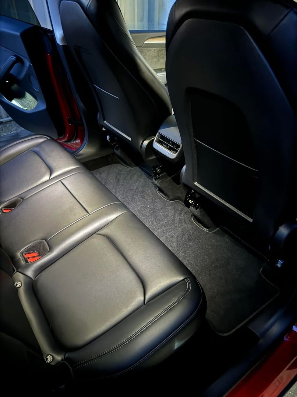 Clean rear seat and carpet inside a Tesla Model Y, second angle