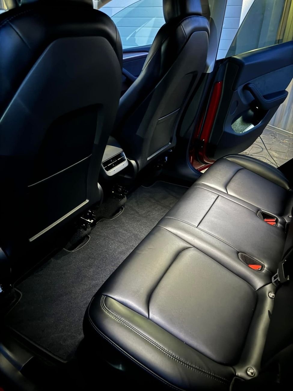 Clean rear seat and carpet inside a Tesla Model Y